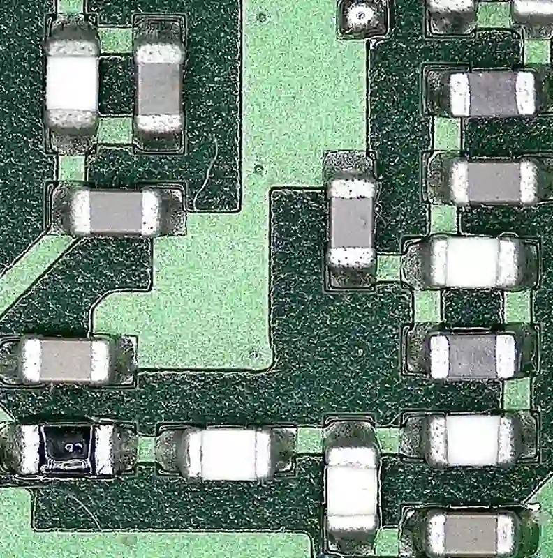 Close-up of component solder area and surrounding soldermask coverage; appearance cannot replace process parameters.
