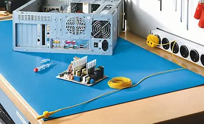 Hobbyist assembling electronics on an anti-static mat
