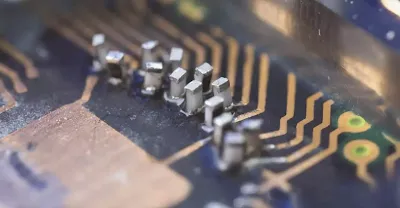 Close-up of tombstoning defect on SMT component during assembly