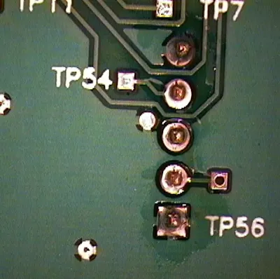 Microscopic view of flux residue and solder particles on PCB