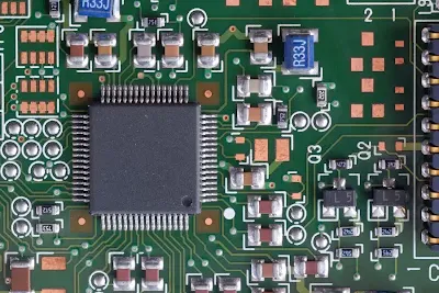 Microscopic view of closely spaced SMT pads on a high-density PCB