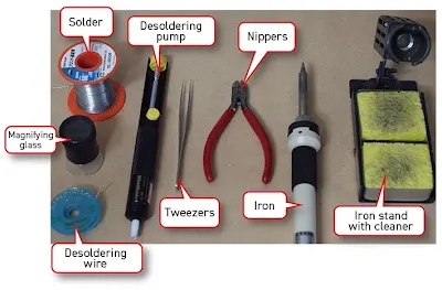 Array of tools including fine-tip soldering iron, solder wire, flux, and tweezers for SMD work