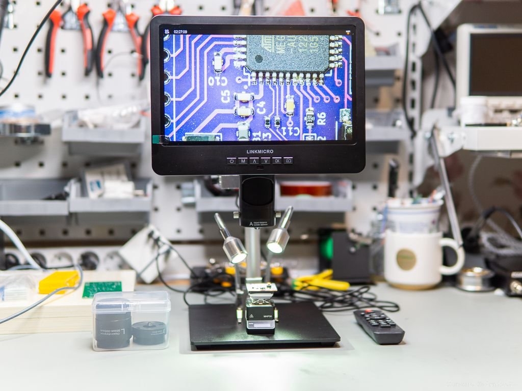 Engineer performing rework on a PCB with fine-pitch components
