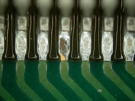 Close-up of flux residue on a soldered PCB surface