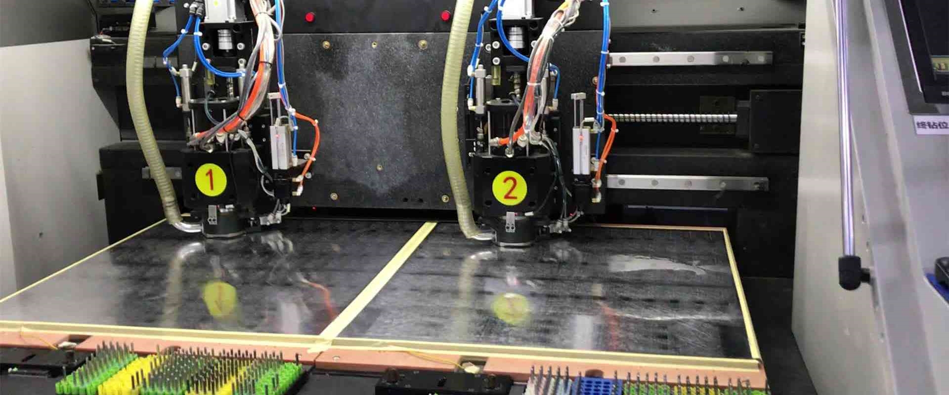 A machine routing individual PCBs from a panel