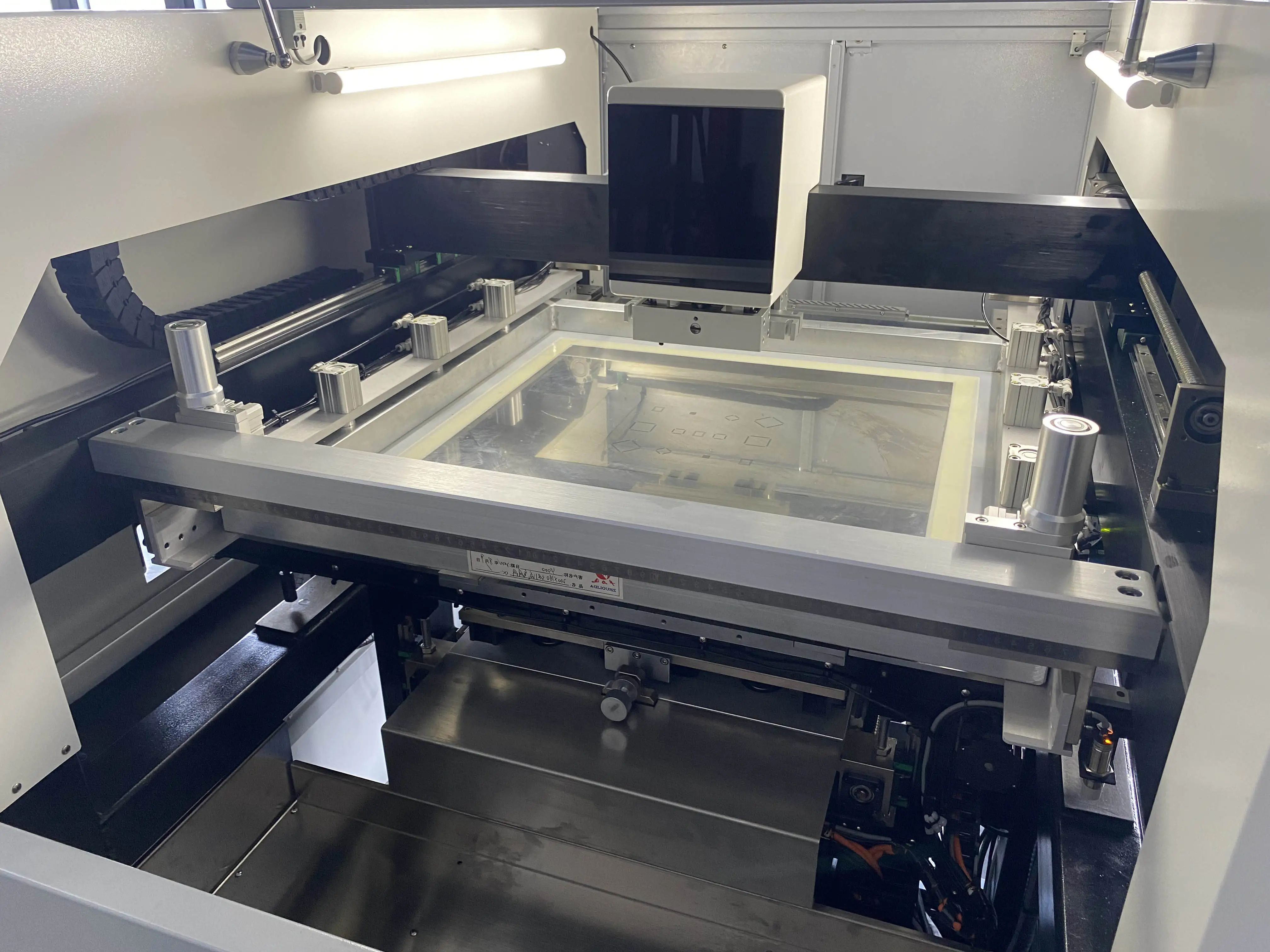 Frame stencil in an automated printer for high-volume SMT solder paste process.