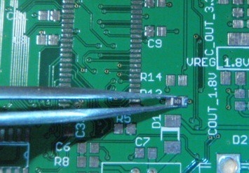 Using anti-static tweezers to place a small SMT component