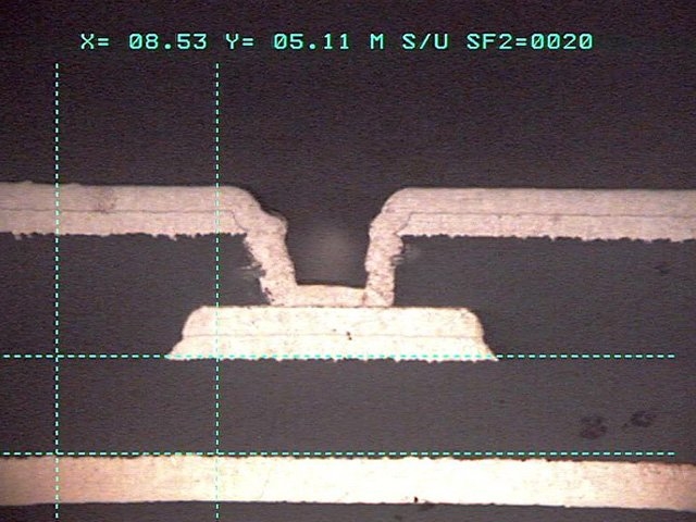 Micrograph showing filled microvia in multilayer automotive control board