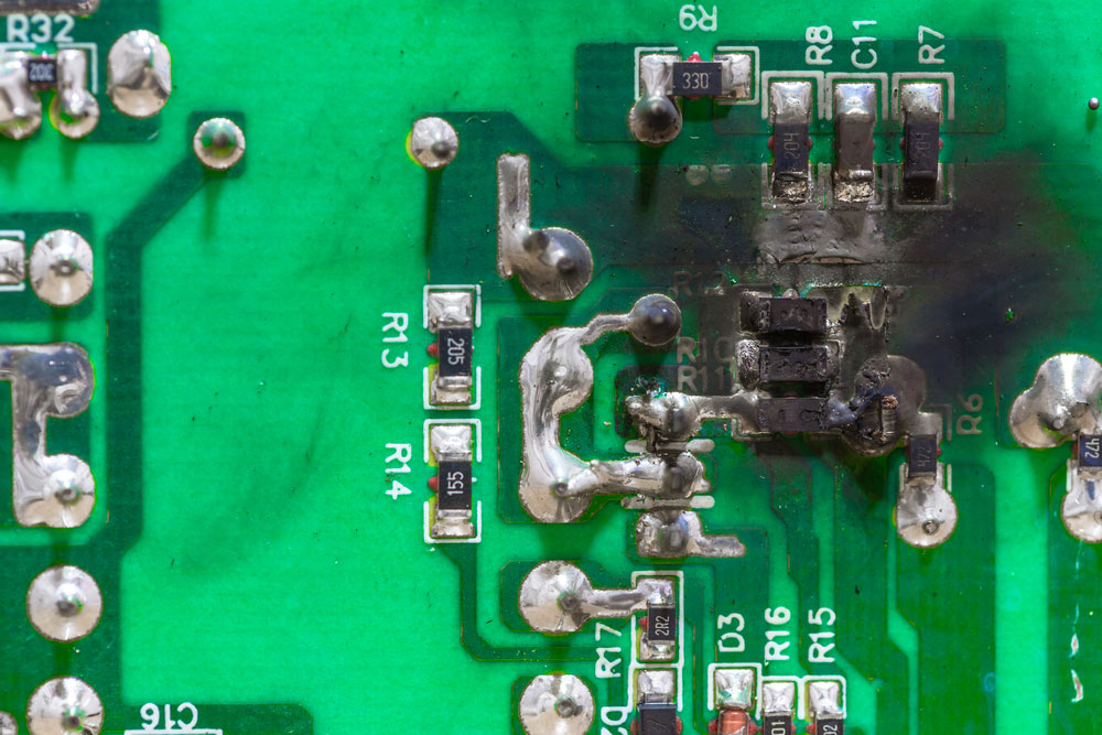 Microscopic view of shorted PCB traces