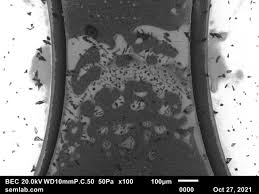 Microscopic view of flux residues on solder joints causing potential corrosion