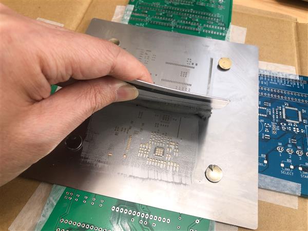 Stencil aligned over PCB for solder paste printing