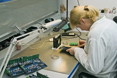 an engineer in IPC-A-600 training reviewing bare PCB samples