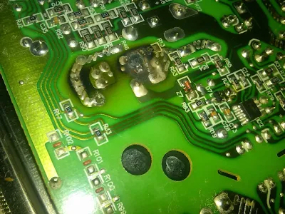 Circuit board showing burnt marks and discolored fuse next to powered components