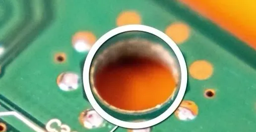 PCB mounting hole with plated barrel