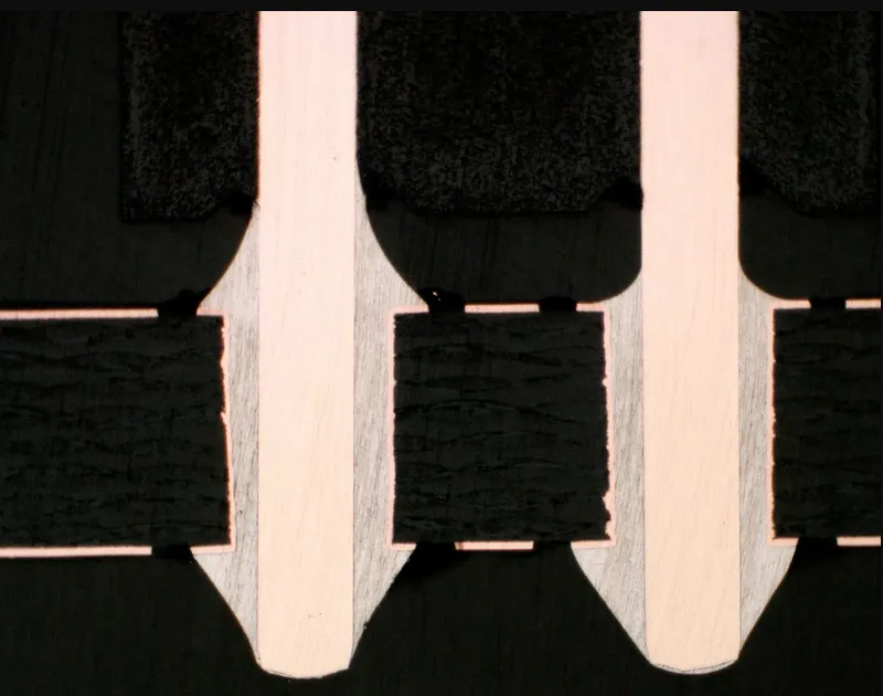 Close-up of filled and capped PCB vias showing how hole structures and surface treatment affect manufacturing boundaries