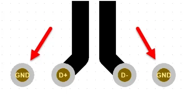 Add ground stitching vias adjacent to differential via transitions