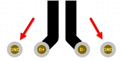 Add ground stitching vias adjacent to differential via transitions