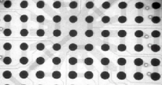 X-ray image indicating non-uniform heating under a BGA; lower-row balls appear larger than top-row balls