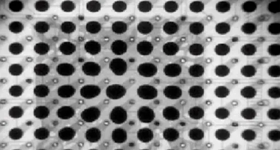 X-ray image showing the popcorn effect: enlarged central BGA balls due to swelling under the die