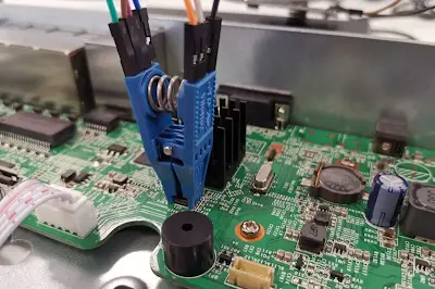 A setup for extracting firmware from a construction equipment PCB using programming tools