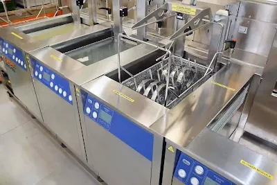Automated aqueous cleaner processing freshly soldered circuit boards