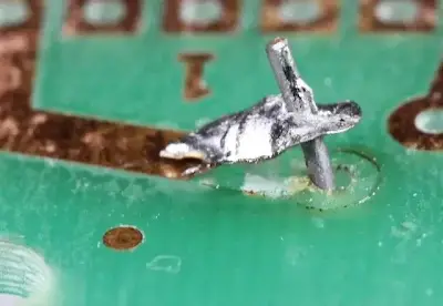 Close-up inspection of lifted pad damage on PCB surface