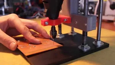 Hobbyist using a drill press with depth stop for PCB drilling