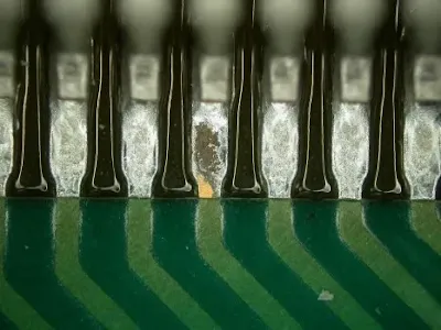 Close-up of flux residue on a soldered PCB surface