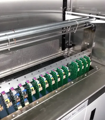 PCB being immersed in a dip coating tank for conformal coating