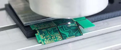 A hobbyist using a shearing tool to cut PCB tabs
