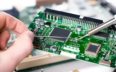 A hobbyist assembling a PCB for a small electronic project