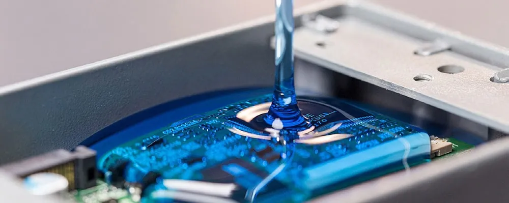 Applying potting resin to an electronic assembly