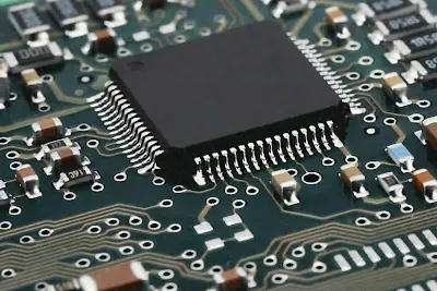 Close up view of small SMT components placed on a PCB under magnification