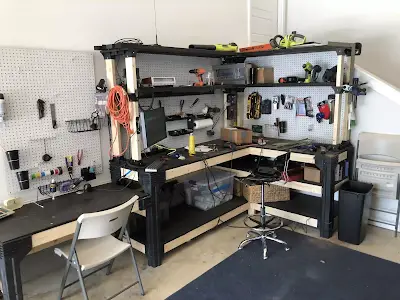 A collection of tools including soldering iron and tweezers on a workbench