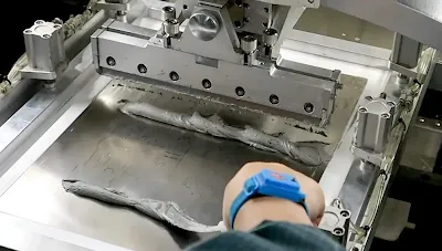 Close-up of solder paste being applied to a PCB via stencil printing