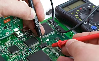 Using a multimeter to test trace continuity on a home-etched PCB